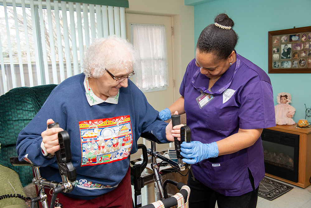 GEM staff helping with walker